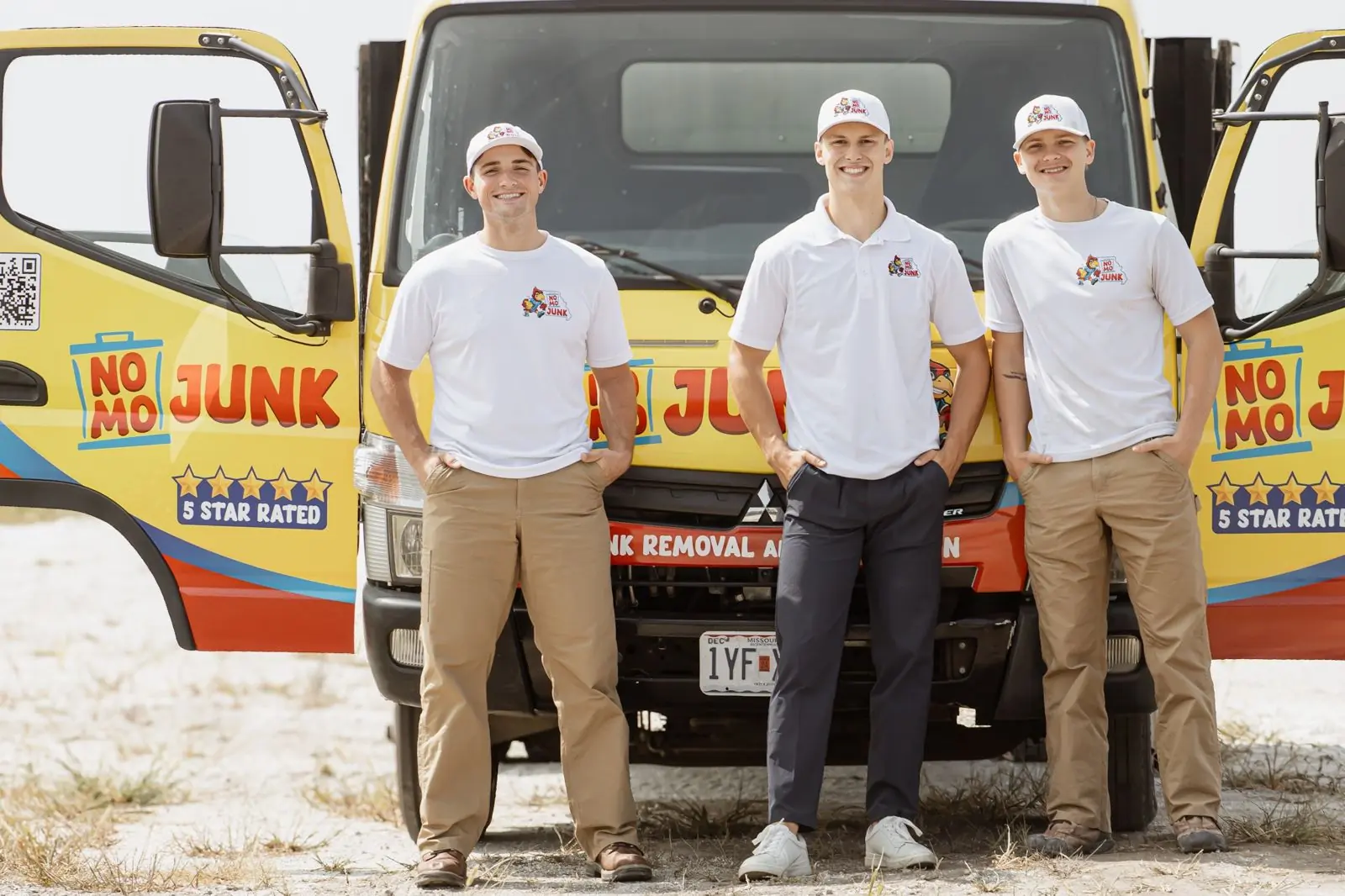 No Mo Junk crew in front of the yellow truck